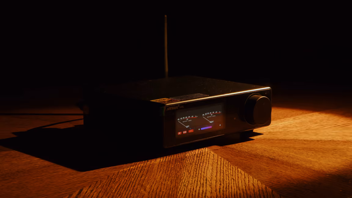 The amplifier at an angle under a spotlight, antenna raised, its vented side panel facing out