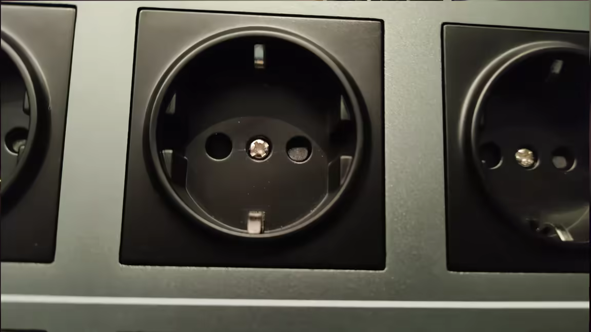 Close-up of the AS-EU08's pure copper Schuko power sockets recessed into the solid metal top