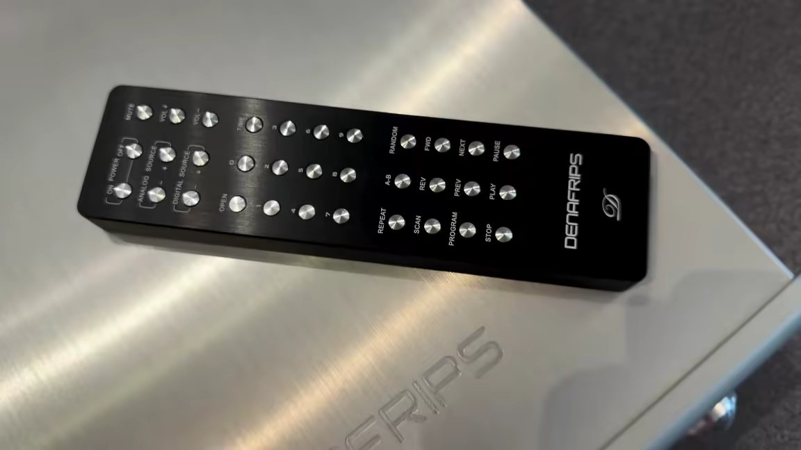 The Denafrips Hades 12th's machined aluminium remote resting on the unit's brushed top plate