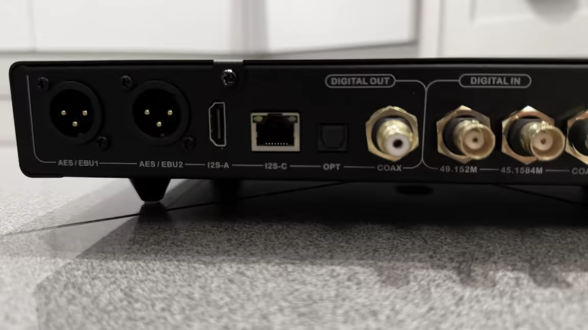 The Denafrips Hermes 12th's labeled rear: dual AES/EBU XLR out, I2S over HDMI and RJ45, optical and coax out, and the BNC clock inputs