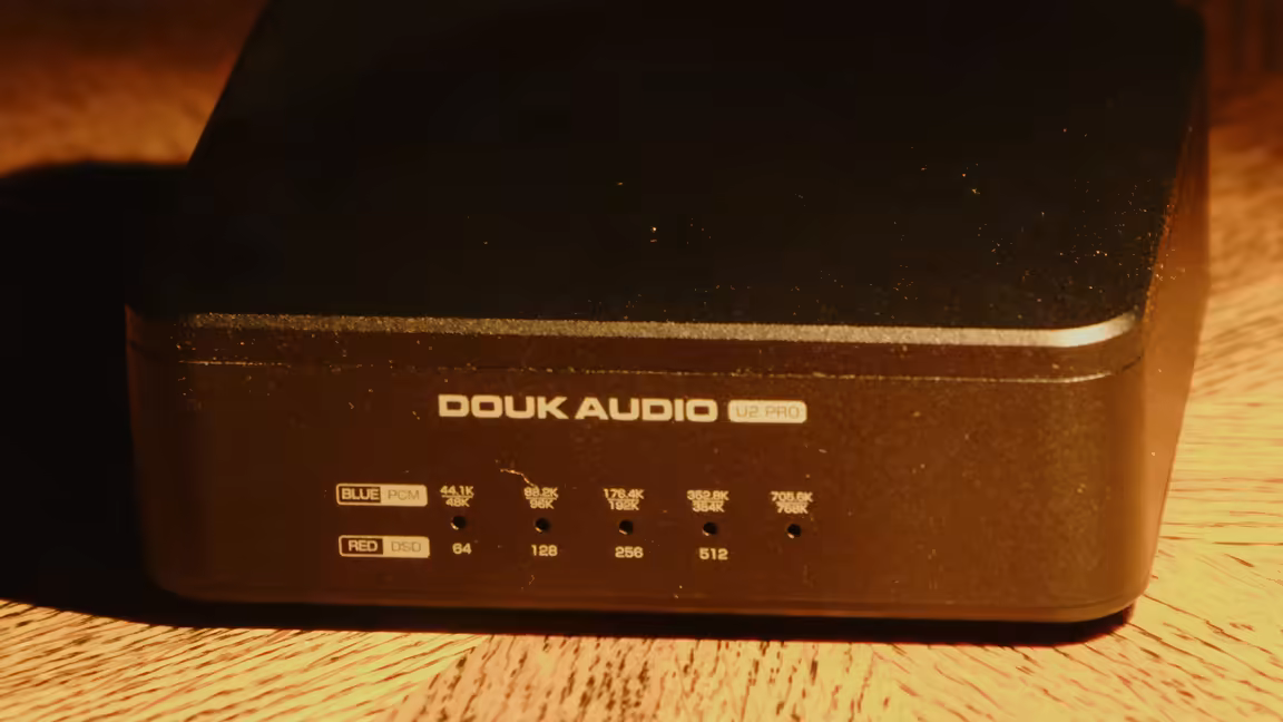 Close-up of the Douk Audio U2 Pro's front indicator: two rows of LEDs, blue for PCM and red for DSD, labelled with sample rates from 44.1/48kHz up to 705.6/768kHz and DSD64 to DSD512