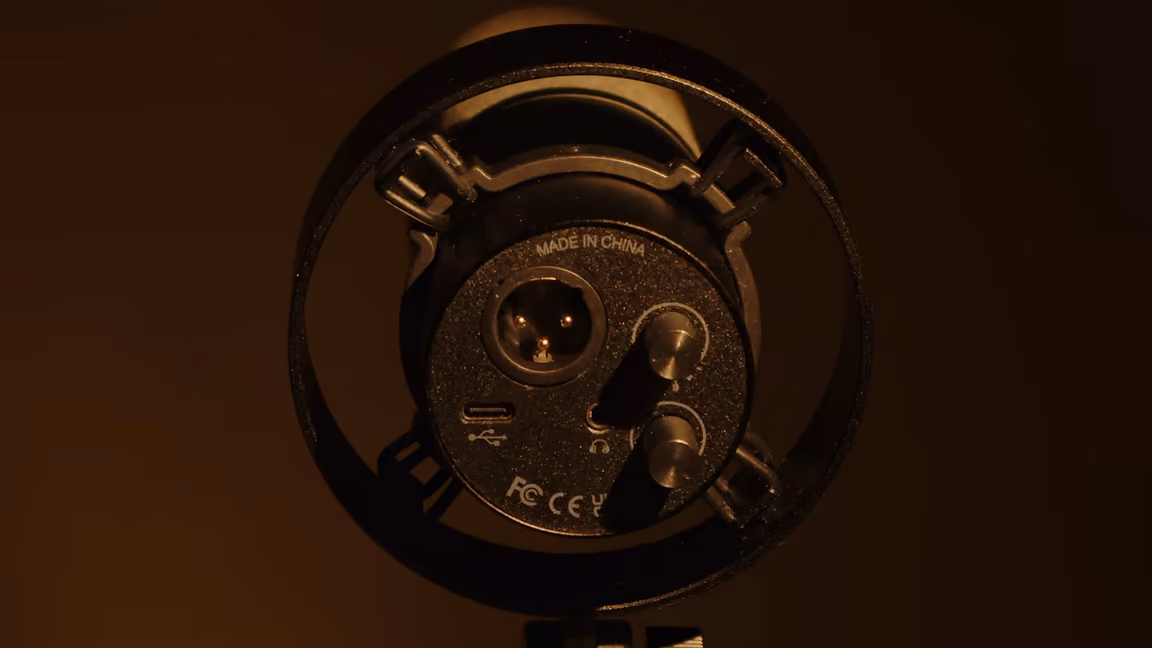 The base plate of the FIFINE K688 seen from below, carrying the three-pin XLR socket, the USB-C port, a 3.5 mm headphone jack and the two knurled gain and monitoring wheels