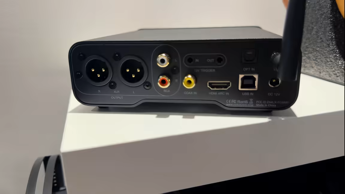 The Fosi Audio ZD3's rear panel: balanced XLR and RCA outputs beside coaxial, HDMI ARC, optical and USB inputs, a 12V trigger in and out, the DC 12V jack and the Bluetooth antenna