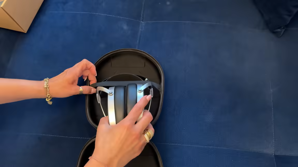 Top-down view of the Ananda Nano in its case, showing the hybrid suspension headband and silver yokes