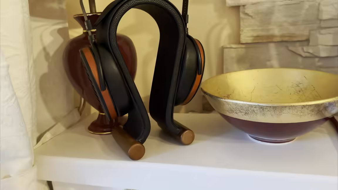 The HIFIMAN Arya Organic on a stand, showing its wood-veneer earcups and suspension-strap headband