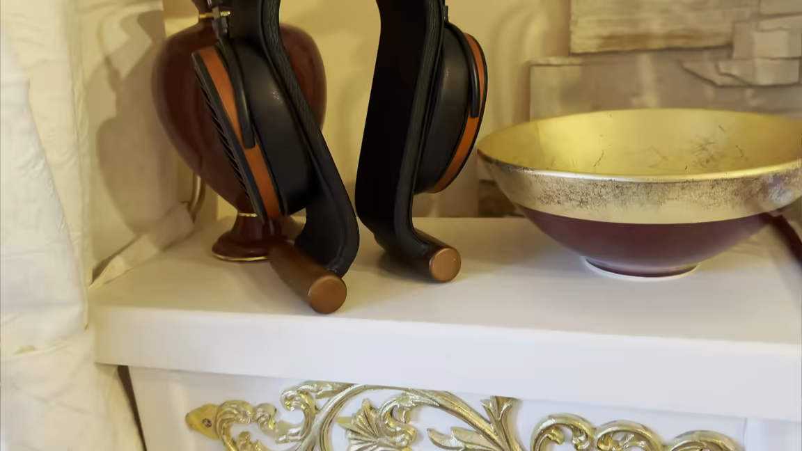 Close-up of the Arya Organic's wood-veneer ring around the black earcup and open grille