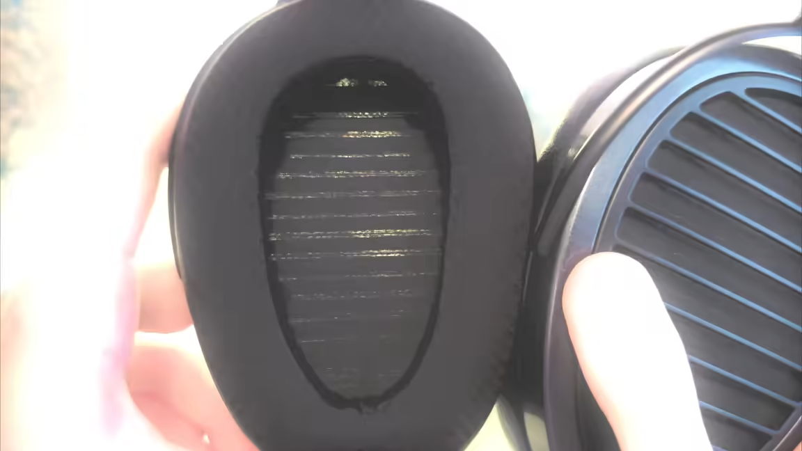 Close-up of the Arya Stealth's oversized three-material hybrid ear pad and the grille behind it