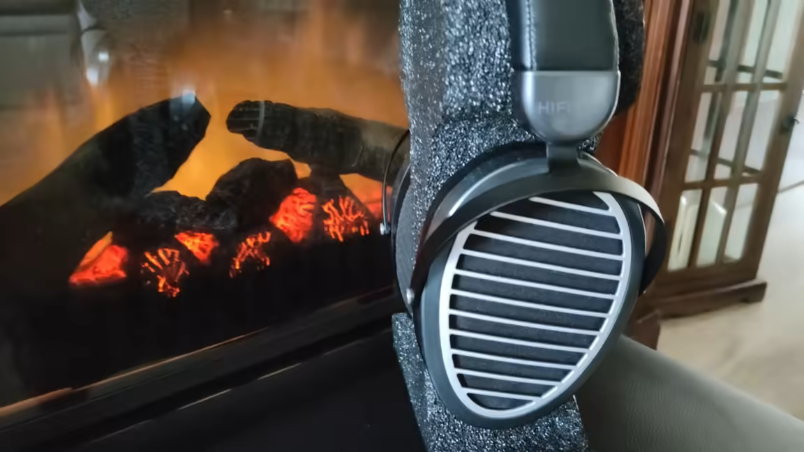 The HIFIMAN Edition XS on a stand, showing its oval slatted Window Shade grille and leather headband
