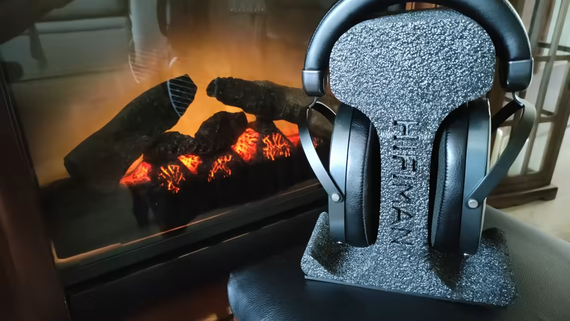 The Edition XS on a stand, showing its solid one-piece leather headband that replaces the suspension strap of earlier HIFIMAN models