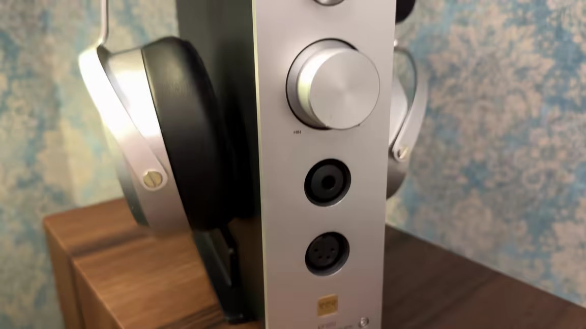 Close-up of the EF500's front headphone outputs: a single-ended 1/4-inch jack above a balanced 4-pin XLR, below the volume knob