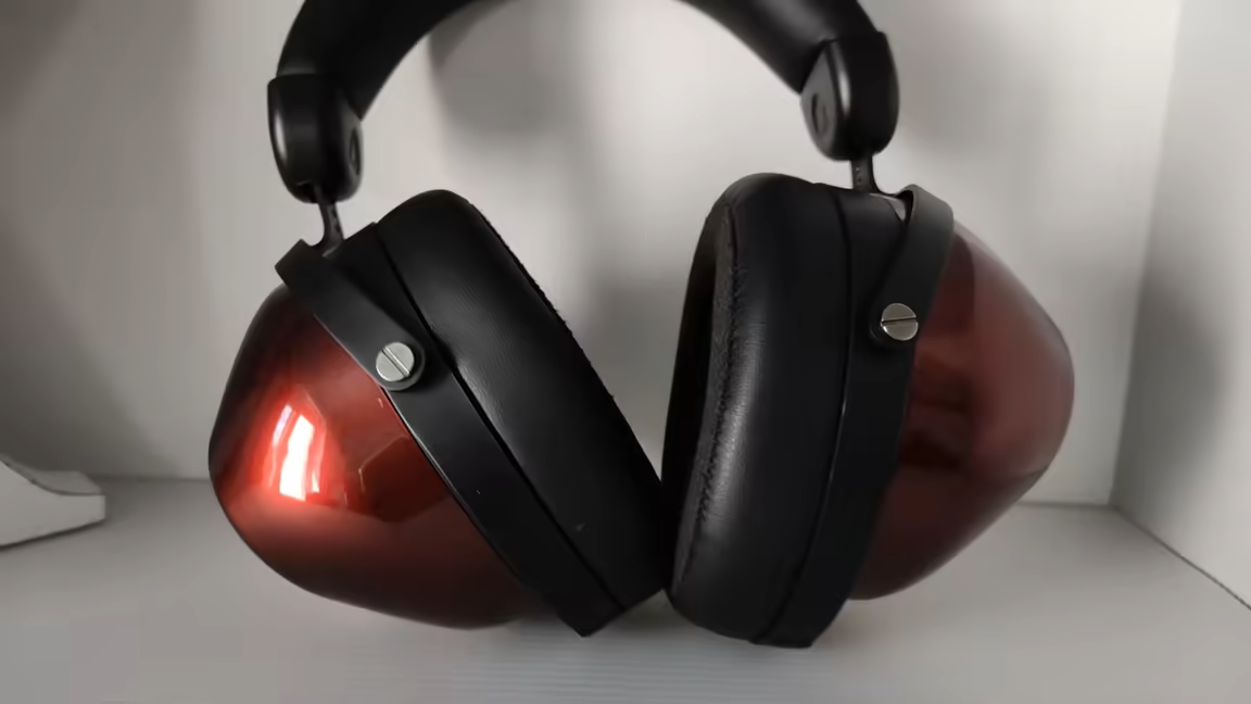 The inner side of both HIFIMAN HE-R9 cups, showing the soft but shallow black ear pads against the glossy red housings