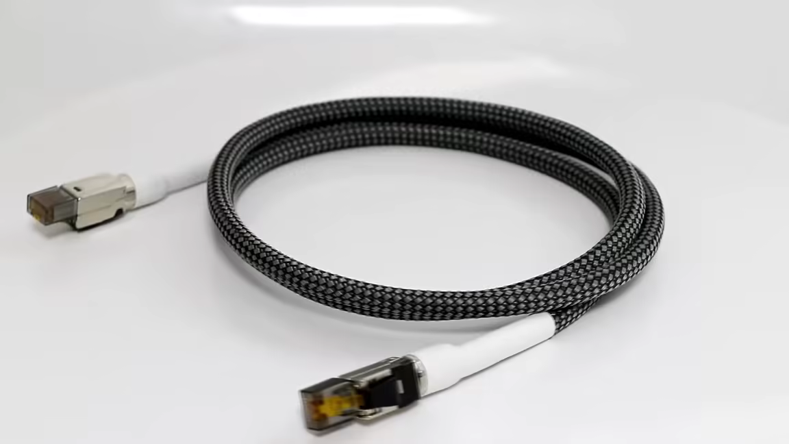 The CAT 8 Ethernet cable with its grey-and-black braided jacket and metal-shielded RJ45 connectors