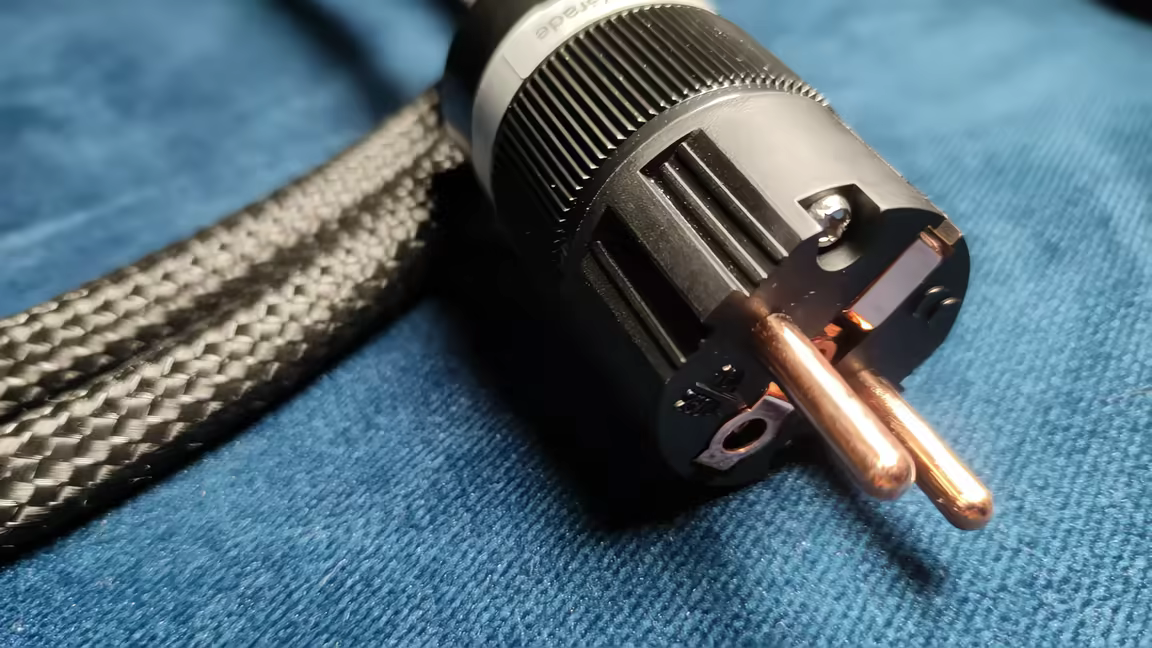 The P903M0 power cable's Schuko plug with its unplated bare copper prongs and braided jacket