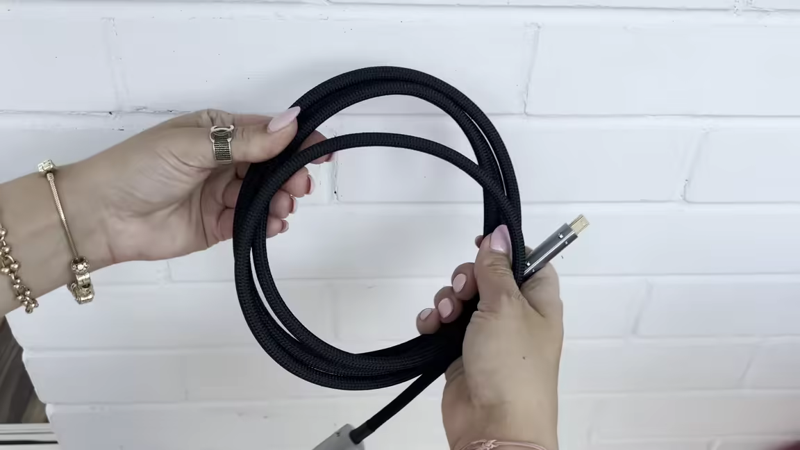 The Monosaudio USB cable's soft black braid coiled loosely, ending in a gold-plated plug with an aluminium connector shell