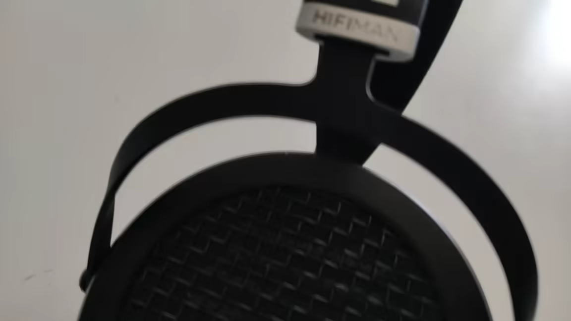 The HIFIMAN Sundara's metal headband yoke and branded suspension strap above the open-back grille