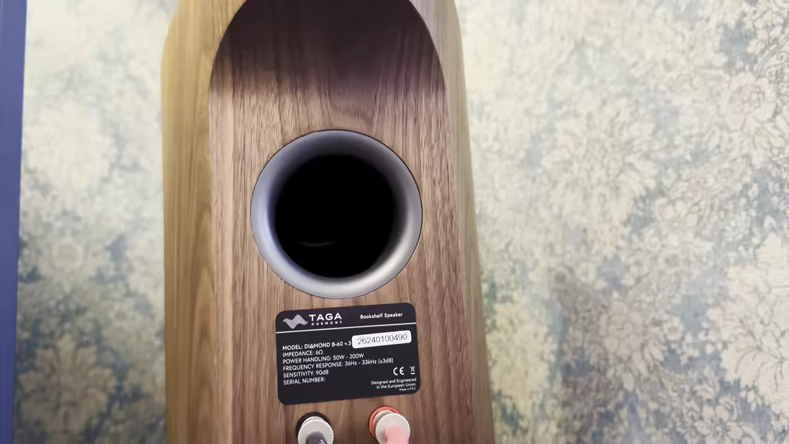 The Diamond B-60's wood-veneer rear: the bass reflex port above the spec label and binding posts