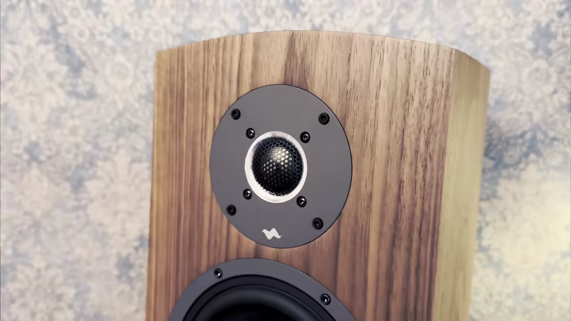 The B-60's 36mm titanium dome tweeter with its metal mesh, recessed into the curved wood-veneer front baffle