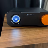 The Fosi Audio ZD3's front panel: the round display reading volume 50 with GAIN, OPT and PCM labels, the Fosi Audio ZD3 logo, and the large orange volume knob