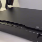 The HIFIMAN Serenade's front: a stepped glossy faceplate, three headphone outputs, top-mounted control buttons, and the heavy analog volume knob