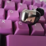 Close-up of a HIFIMAN Svanar Wireless earbud showing its chromed swan-shaped nozzle, silver-and-black body, and silicone ear tip