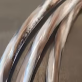 Close-up of the Brown Sugar BSSC3300's twisted brown-and-white conductors under clear insulation, printed with the Melodika model name