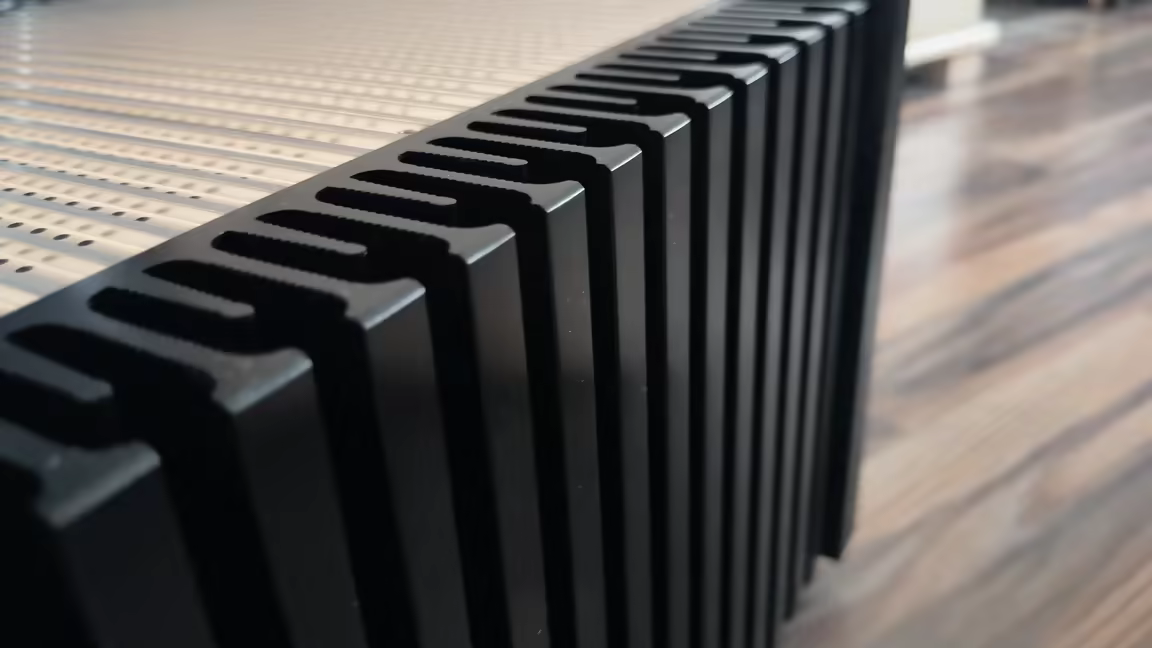The AD-1PA+'s machined black side heatsink, its fins spaced along the full length of the chassis for thermal dissipation