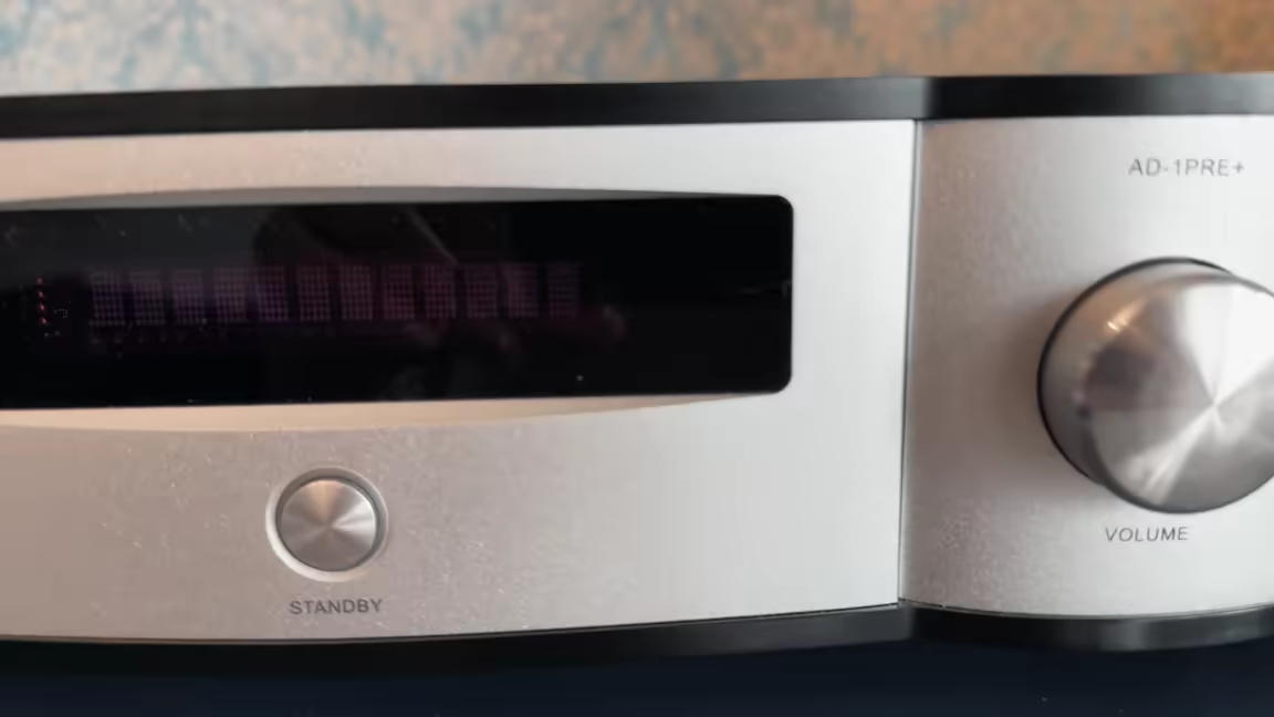The matching AD-1PRE+ preamp's front: its dot-matrix display, standby button, and milled-metal volume knob