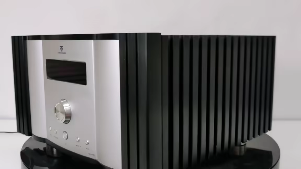 The Tonewinner AD-2PRO+ from the side: its silver-and-black chassis flanked by the large black heatsink fins that run the full depth of the unit