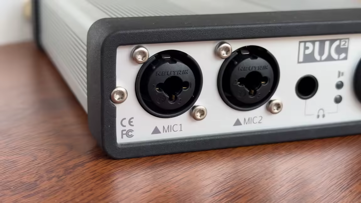 Close-up of the PUC2's front panel: two Neutrik combo XLR/quarter-inch mic inputs (MIC1, MIC2) beside the headphone output