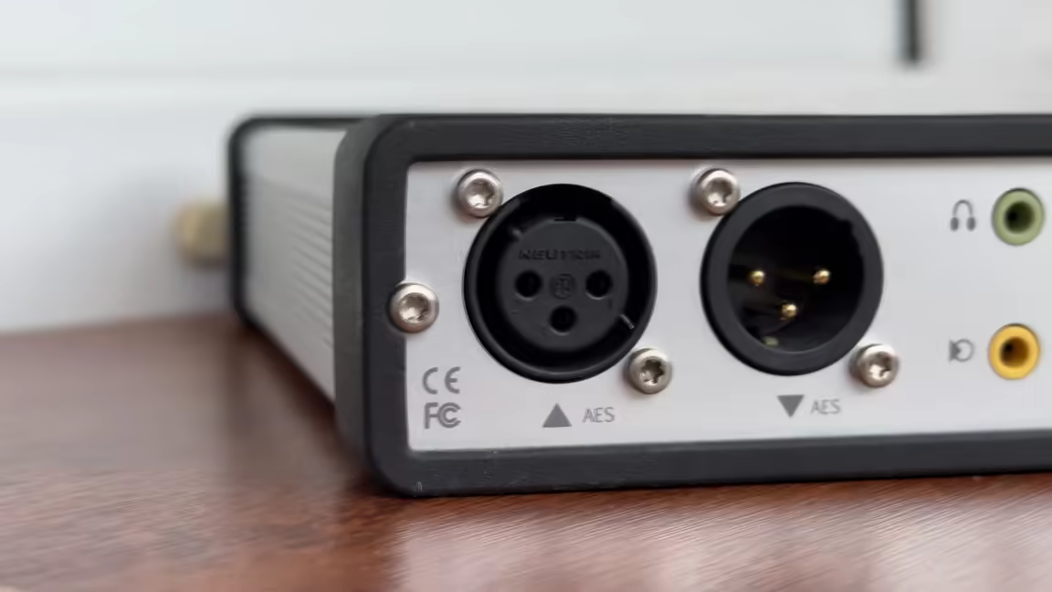 The PUC2's rear connections: the balanced AES digital input and output beside the green headphone and yellow AUX outputs